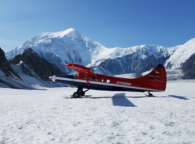 One of the best things to do on any Alaska itinerary A small airplane surrounded by snow and mountains