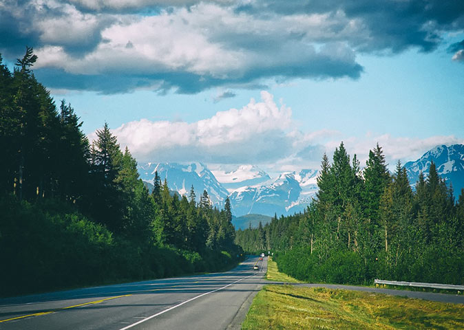 Seward highway - Starting our Alaska road trip an empty highway with pine trees on both sides