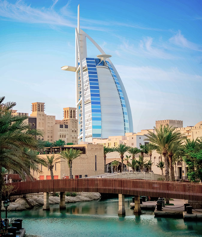 a bridge, brown stone buildings and a modern highrise hotel