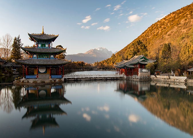 a body of water, a pagoda and mountains