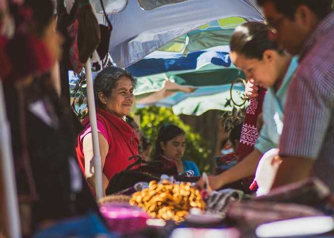 Locals and expats at a market stand in Oaxaca de Juarez Locals and expats at a market stand in Oaxaca