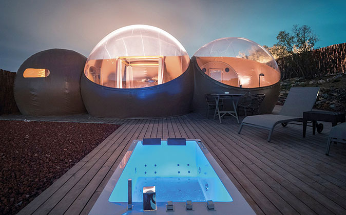 A unique and romantic place to stay in Spain three bubble shaped rooms with a hot tub in front of it