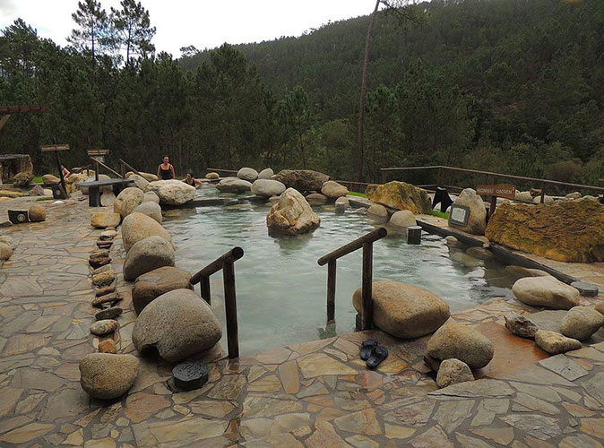 A romantic getaway to Galicia's hot springs an outdoor thermal bath surrounded by brown rocks and green hills