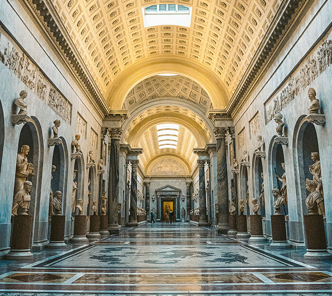 The Vatican Museums, a must see when you visit the Vatican A museum hall lined with statues on both sides