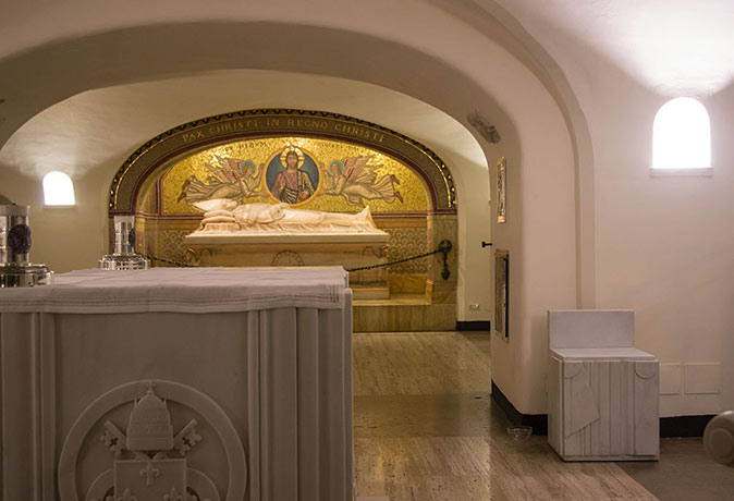 The Vatican Grottoes, a must visit in Vatican City a tomb with a marble statue on top of it