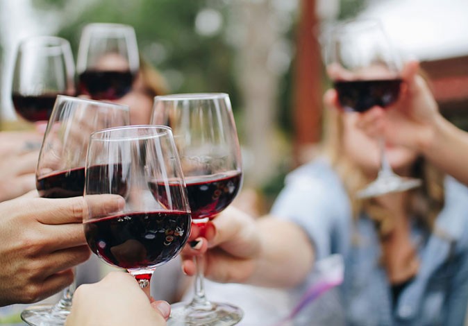 A guided tour of the vineyards in Temecula 5 hands holding wine glasses with red wine