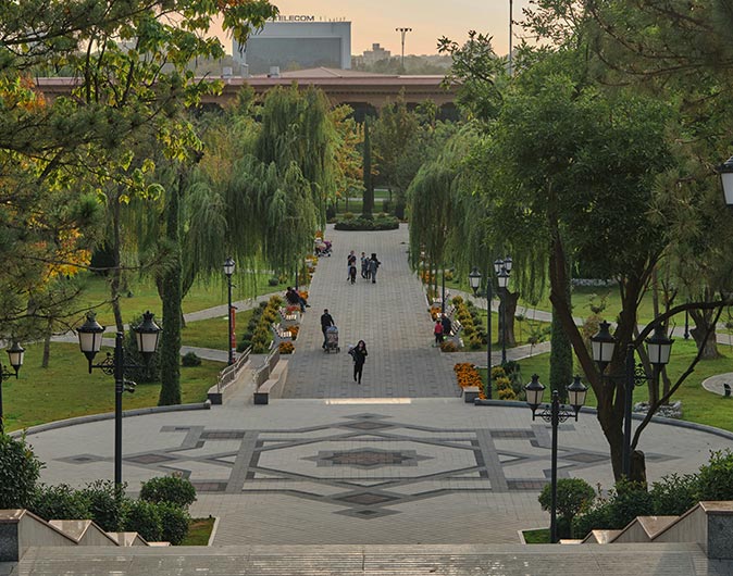 Living in Tashkent, Uzbekistan A square and path with people, lined with trees on both sides