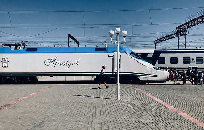 Public transport in Uzbekistan A modern looking train stopped at an almost empty platform