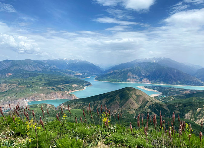 View from the top of Kungurbuka Mountain Scenic view of green hills and a bright blue lake