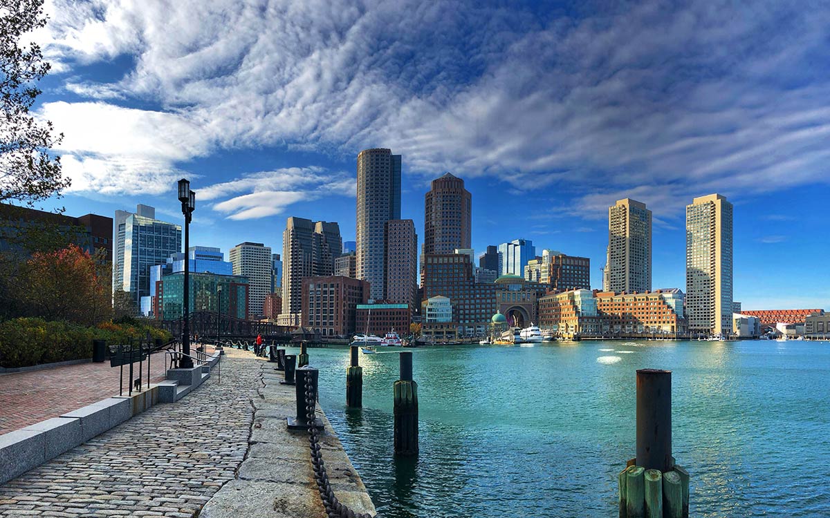 waterfront with a boardwalk and many high-rise buildings