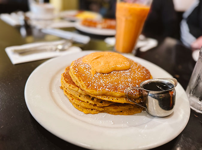 local tips for where to eat in LA A plate of pancakes with a juice in the background