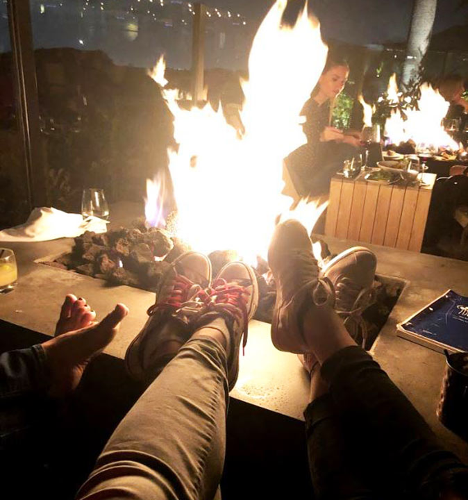 A local tip for the best bars in LA 3 people's feet around an outdoor fireplace