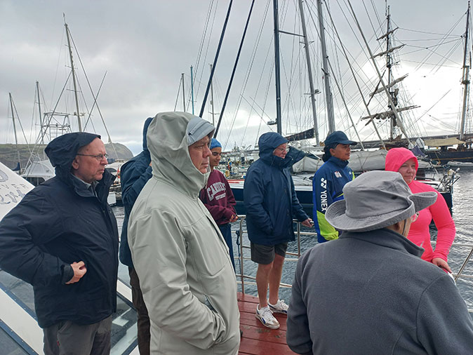 A group of people on a boat facing away from the camera