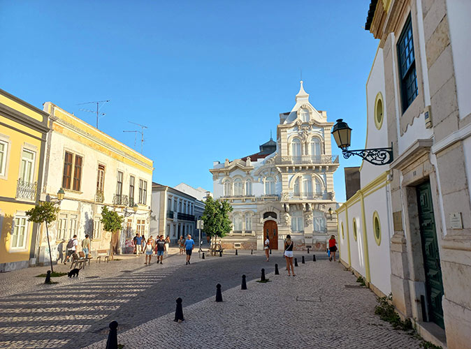 Typical Portuguese street lined with historic brown and white buildings