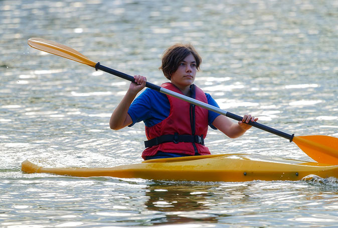 Kayaking is a fun activity to do with kids in Marbella Close-up of a boy in a bright yellow kayak