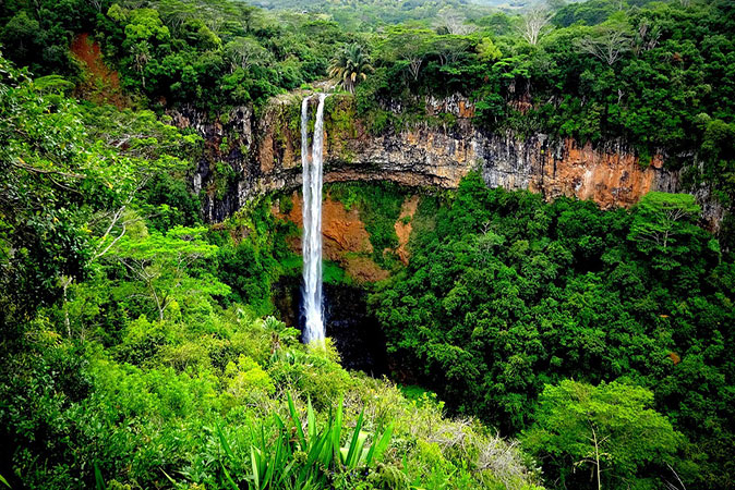 Tropical Mauritius A high waterfall surrounded by lush greenery