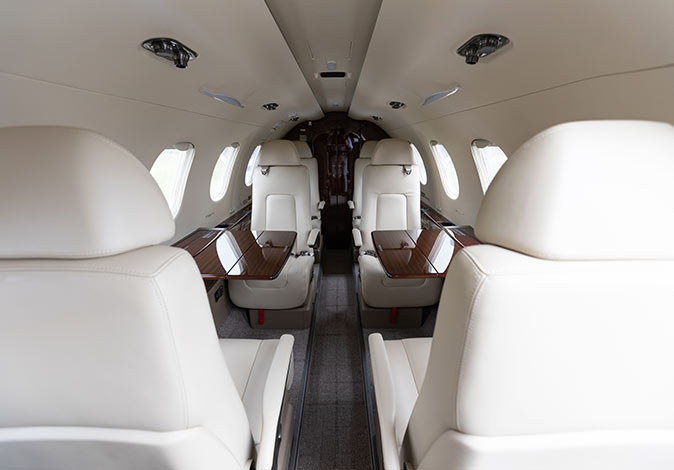 Private jet for rent The interior of a small private jet with 4 white leather seats