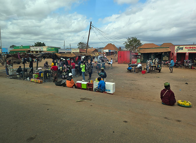 A typical town in Malawi, Africa Several vendors on the side of a road in Malawi, Africa