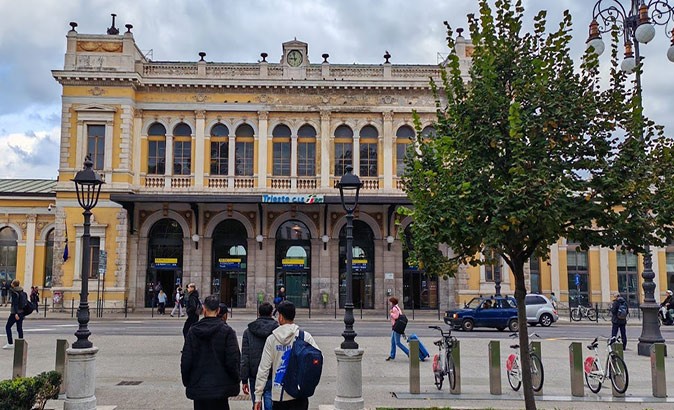 How to get from Trieste to Venice by train People walking towards the entrance of a train station