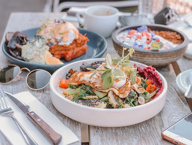 Things to know about the food in Australia 3 plates with brunch dishes on a table