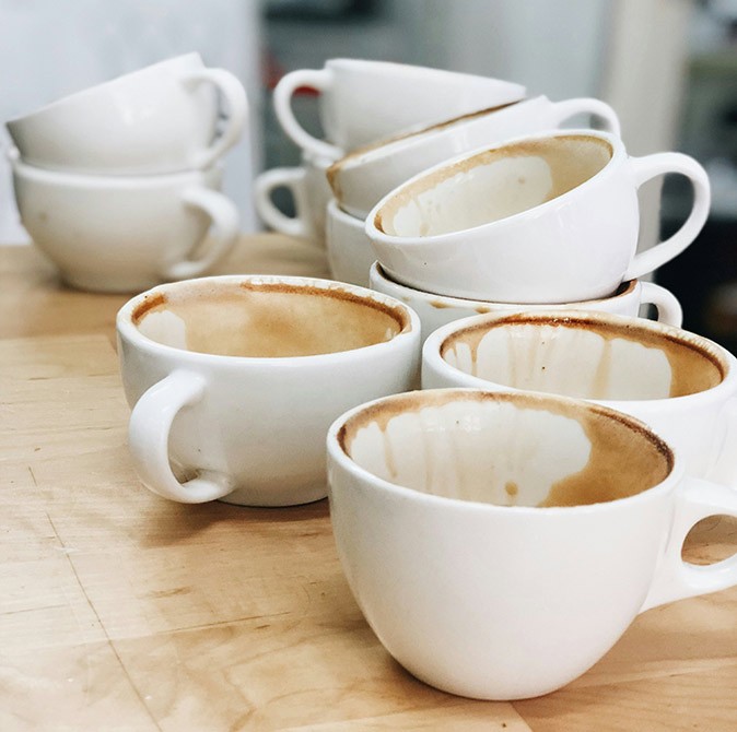 Possible issues when staying at a coliving in Spain dirty white coffee cups stacked up