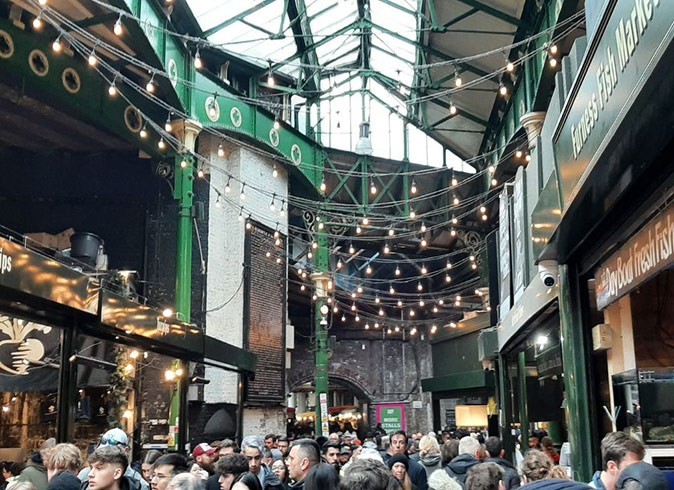 A covered market with a lot of people