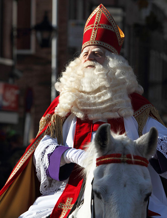 A controversial Christmas tradition in the Netherlands A man dressed like Saint Nicolas sitting on a white horse