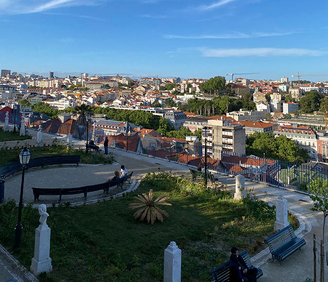 One of the most popular neighborhoods in Lisbon to live in A city park with houses in the background