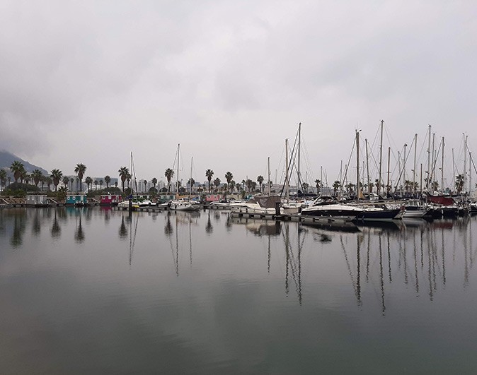 Things to know when chartering a yacht in Spain A large number of boats in a marina on a very gray and cloudy day