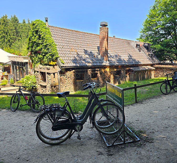 Bicycles parked in front of a traditional stone building that houses a restaurant