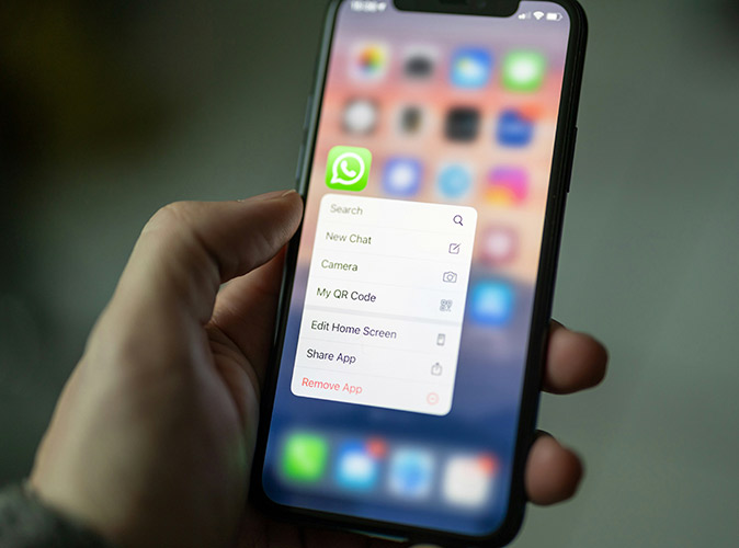 The Spanish love using WhatsApp for everything A hand holding a phone with the Whatsapp icon visible and the rest of the screen blurred