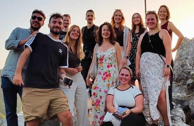A group of remote workers who joined Tursi Digital Nomads A group of people standing together posing for the camera, smiling