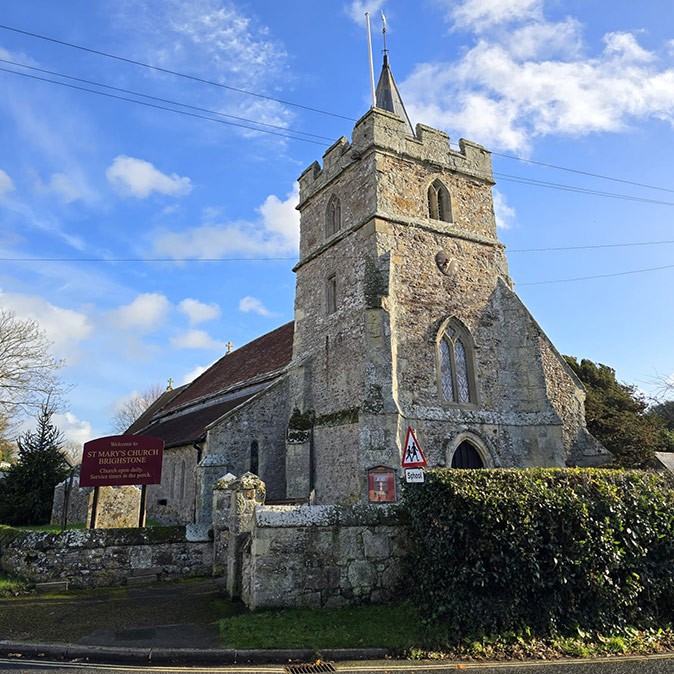 The rich history is what draws many tourists to the UK A brown and beige historic church with some greenery in front of it