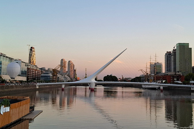 Tips for enjoying life in Buenos Aires A modern white bridge around sunset with buildings on both sides