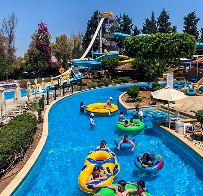 Things to do in Limassol A water park showing slides and various people on tubes in a swimmingpool