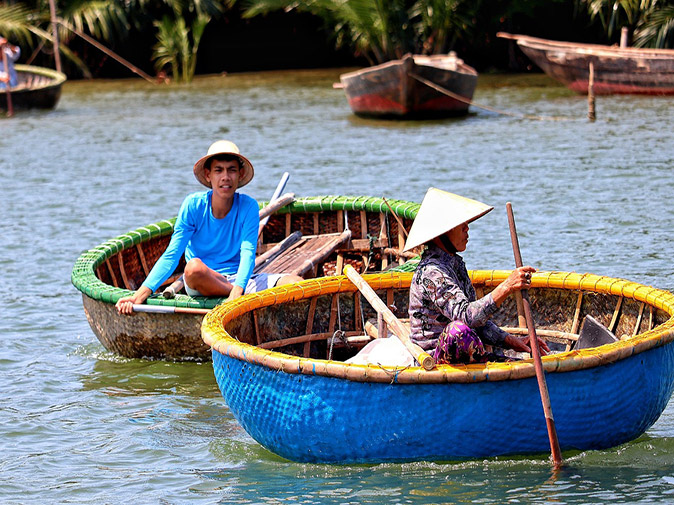 Why go on a Mekong River cruise 2 people sitting in 2 basked shaped boats on a river