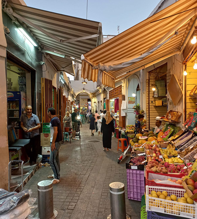 A typical Moroccon market showing several vendors on a narrow street