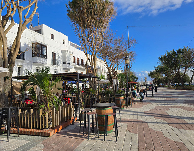 One of the best parts of Tarifa A row of restaurants along a paved road with various trees