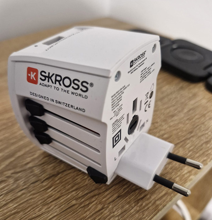 Tech to bring when traveling abroad A large, white universal adapter