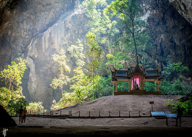 Things to do in Hua Hin, Thailand A shrine inside a large natural cave showing some greenery and a few people