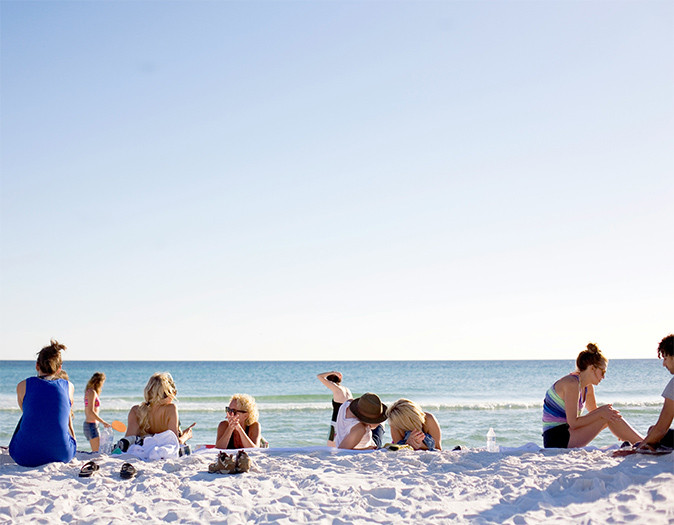 Sharing the good parts of life abroad Several people on a white sandy beach with a blue sky, including myself enjoying life abroad