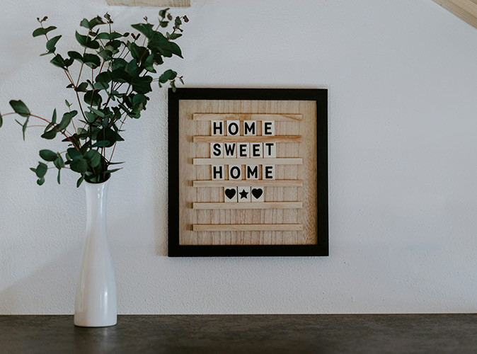 "Home" can be a complacated thing when you are living abroad A sign on a wall rading "Home Sweet Home"