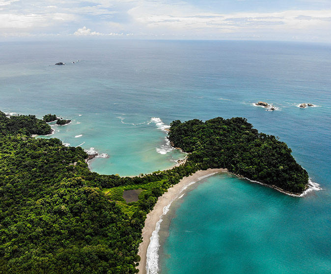 2 bays with sandy beaches and lush greenery