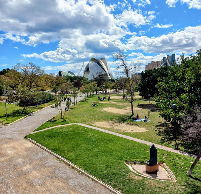 life in Valencia as a digital nomad or remote worker A large park with greenery and a futuristic white building in the background