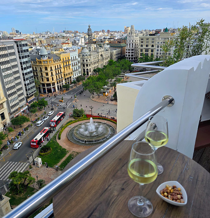 Working remotely in Valencia, Spain View from a rooftop bar overlooking a central square in Valencia with a large fountain