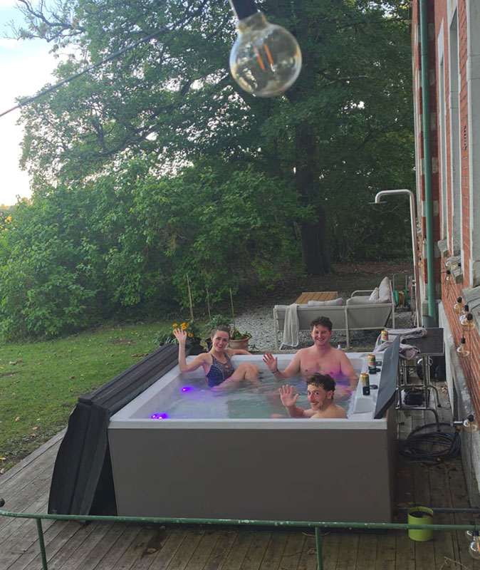 3 remote workers who joined a coliving trip to Sweden 3 remote workers in a jacuzzi waving at the camera