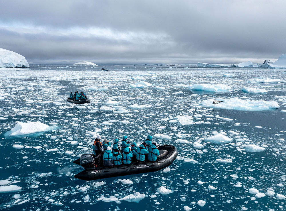 A zodiac filled with people surrounded by water and ice in the Ross Sea