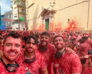 4 men covered in tomato pulp at the La Tomatina festival in Spain